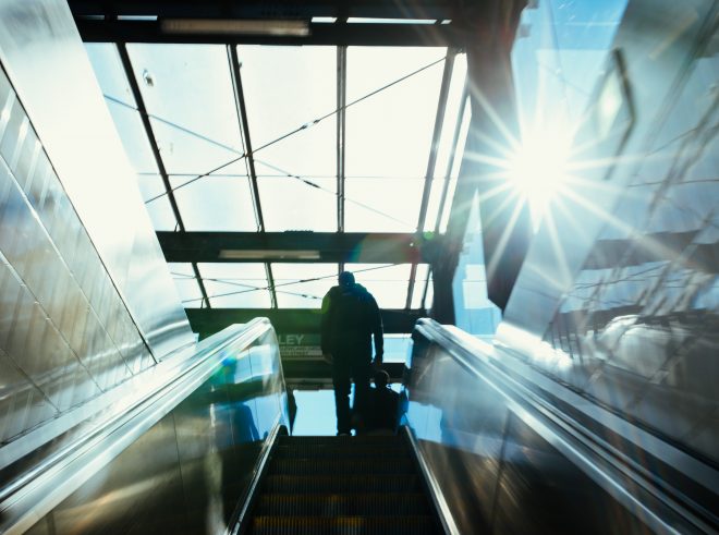 The exit from the Copley MBTA station is a cool blue with the sun shining in from the corner.