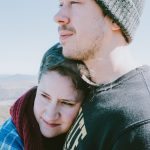 Couple looks off into distance on the top of a mountain in Western North Carolina