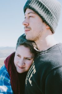 Couple looks off into distance on the top of a mountain in Western North Carolina