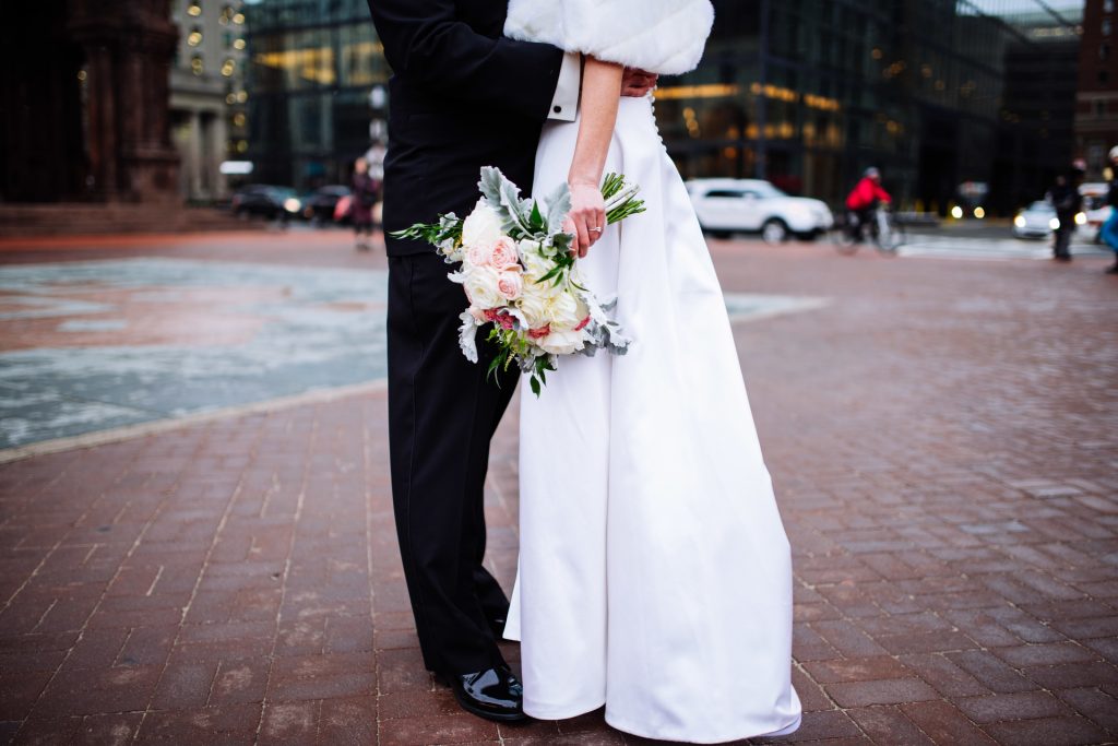 Bridge and groom kiss during their first look in Copley Square on a cold Boston morning.