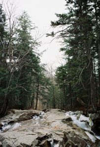 A river running over large rocks in Franconia State Park.