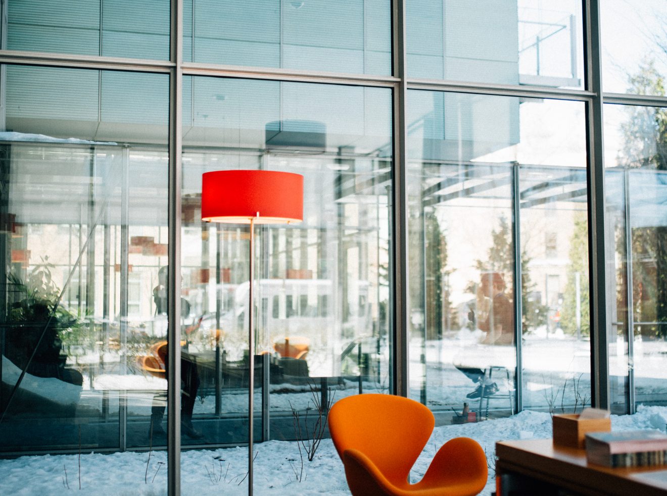 An orange chair and matching lamp inside of the modern Isabella Stewart Gardner Museum.