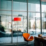 An orange chair and matching lamp inside of the modern Isabella Stewart Gardner Museum.