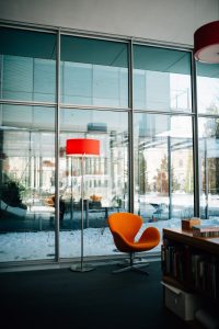 An orange chair and matching lamp inside of the modern Isabella Stewart Gardner Museum.