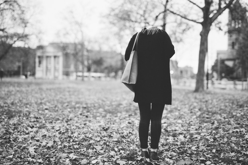 Trendy girl looks down in a Harvard quad