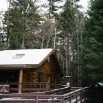 Snow covered cabin shows beautiful browns and yellows
