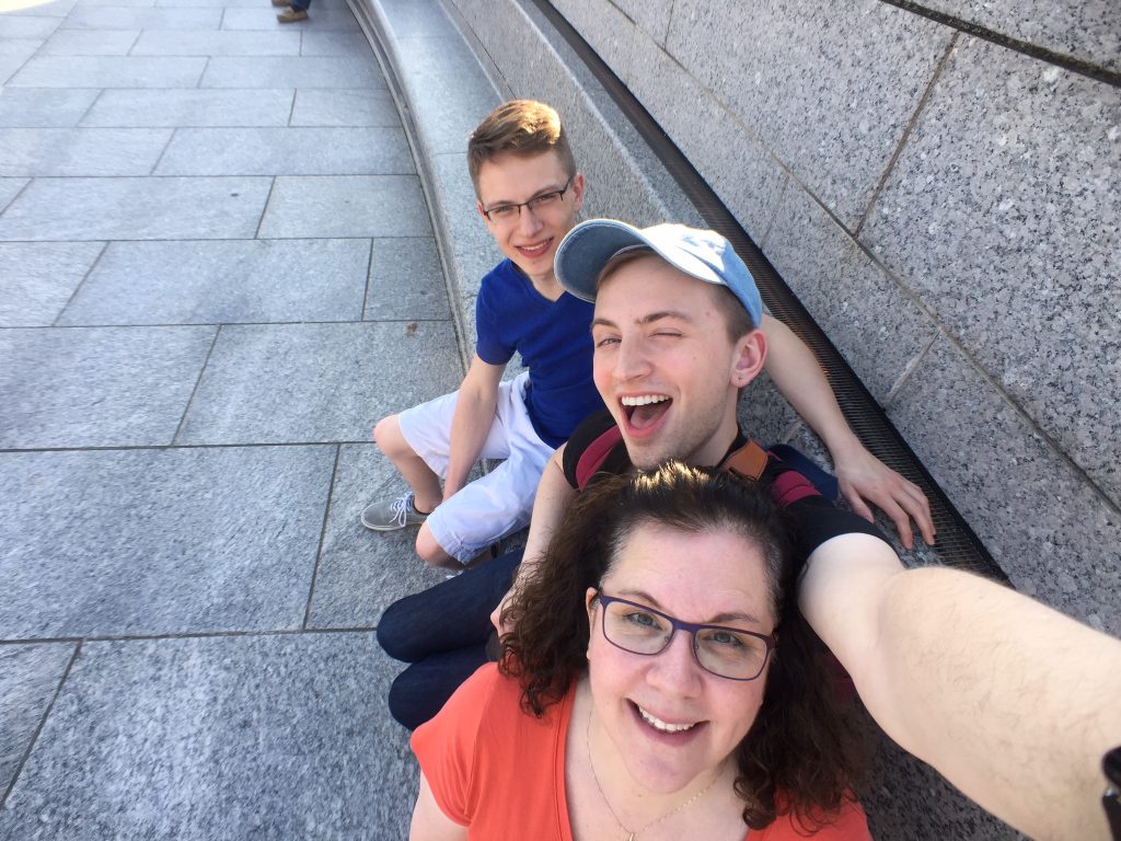 Ford, Wendy, and Bob sitting at the WWII memorial in Washington DC