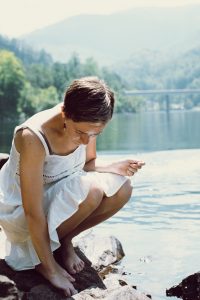 Alyssa sits by the river waiting for totality in Bryson City, NC