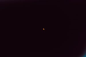 The sun shrinks into a crescent shape.