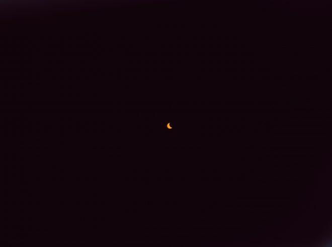 The sun shrinks into a crescent shape.