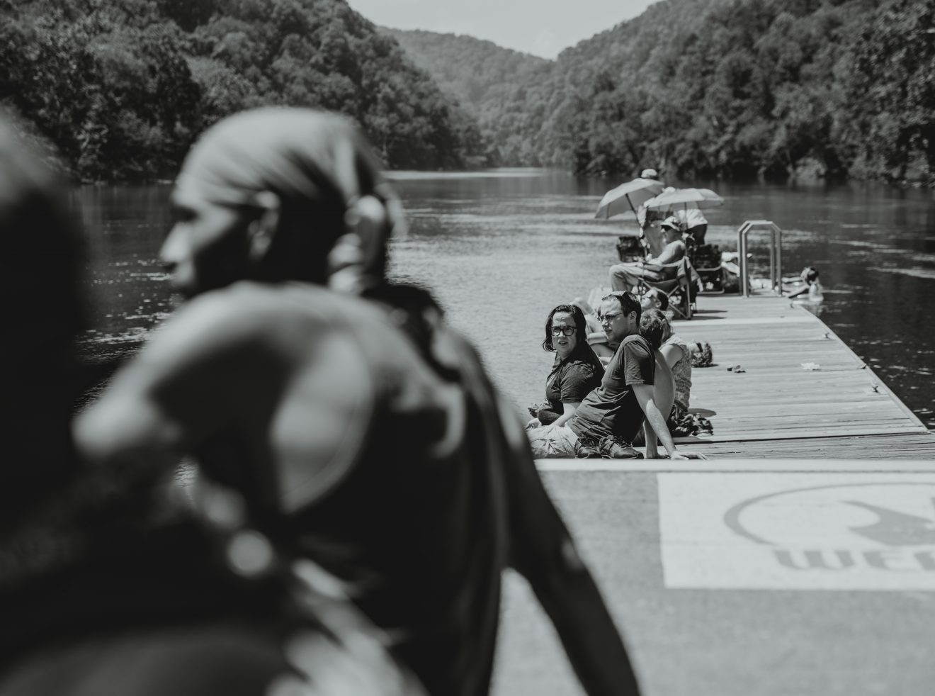 Viewers sit on a dock at the river just south of Fontana Dam waiting for totality.