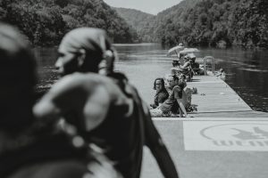 Viewers sit on a dock at the river just south of Fontana Dam waiting for totality.